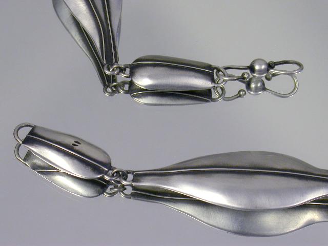organic looking object with silver tentacles