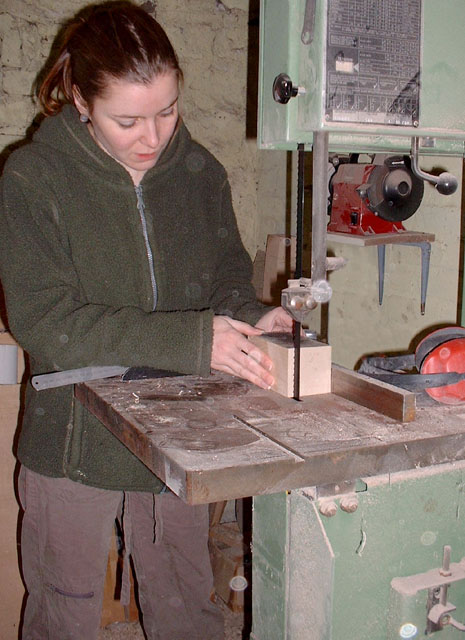 Louise uing a bandsaw to create a new sculpture